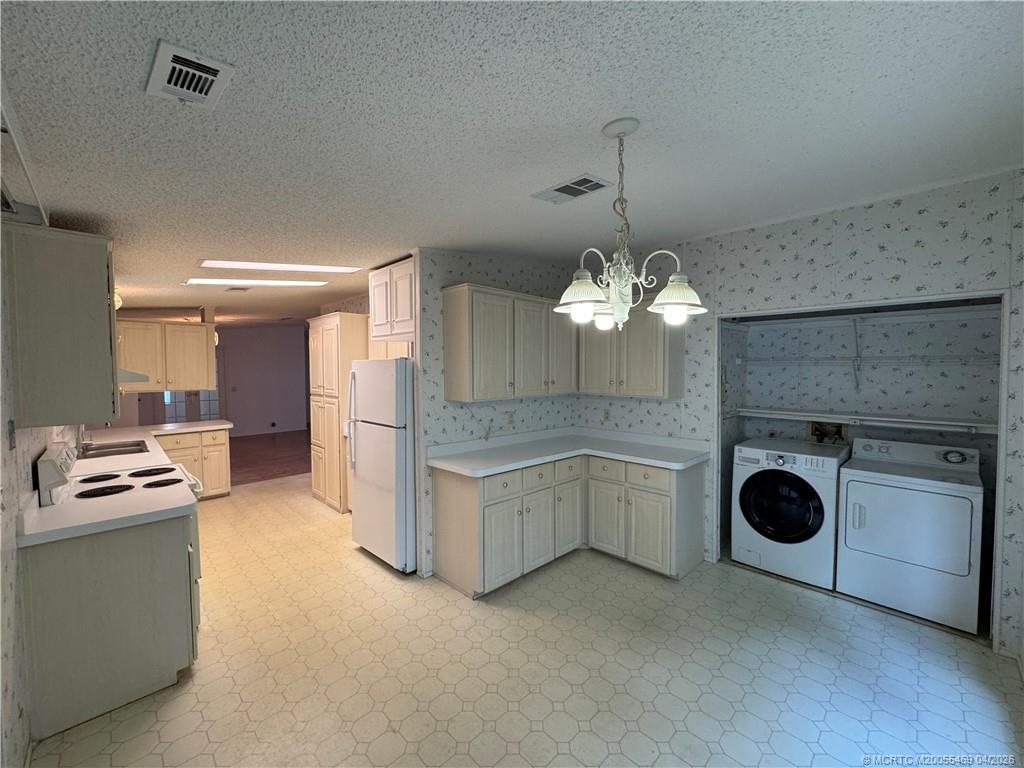 4236 Southeast Sweetwood Way Stuart, FL 34997 - Photo 17 of 50 a kitchen that has a lot of cabinets in it