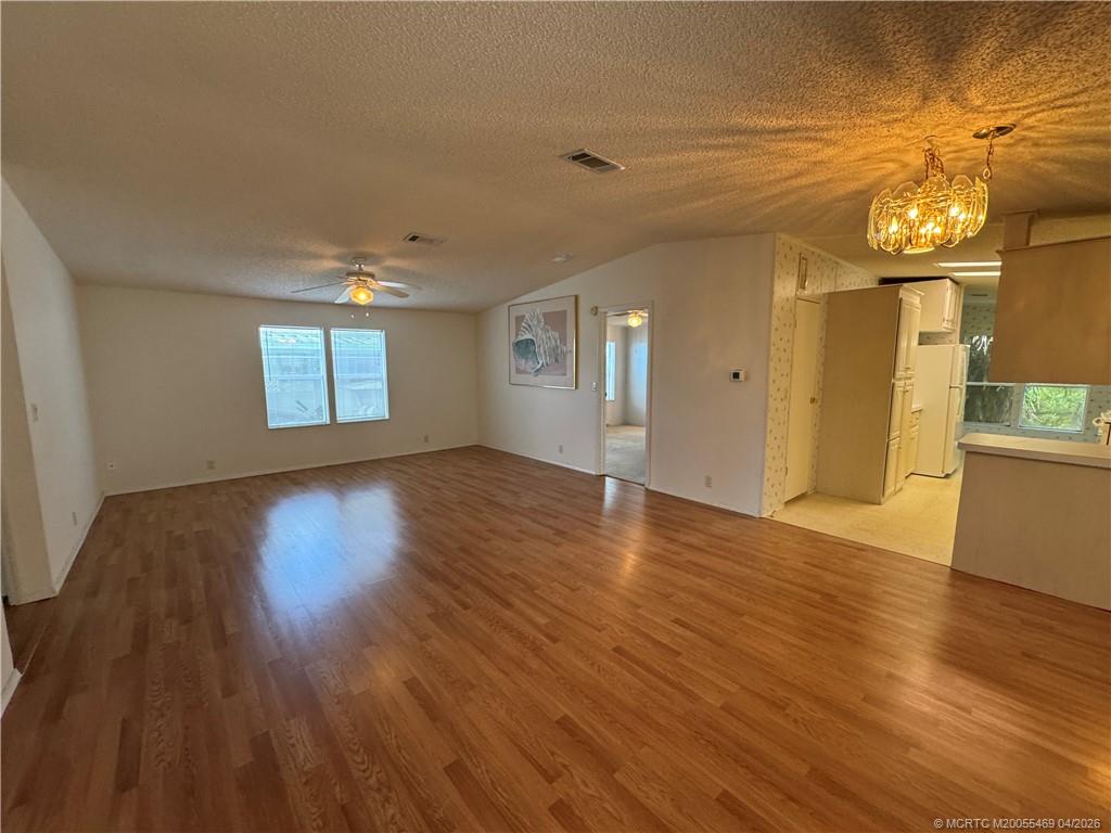 4236 Southeast Sweetwood Way Stuart, FL 34997 - Photo 2 of 50 a view of empty room with wooden floor and fan