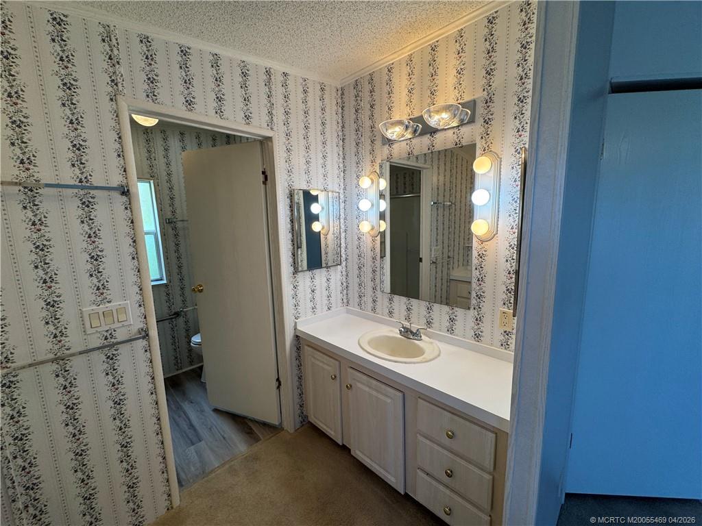 4236 Southeast Sweetwood Way Stuart, FL 34997 - Photo 22 of 50 a bathroom with a double vanity sink mirror and shower