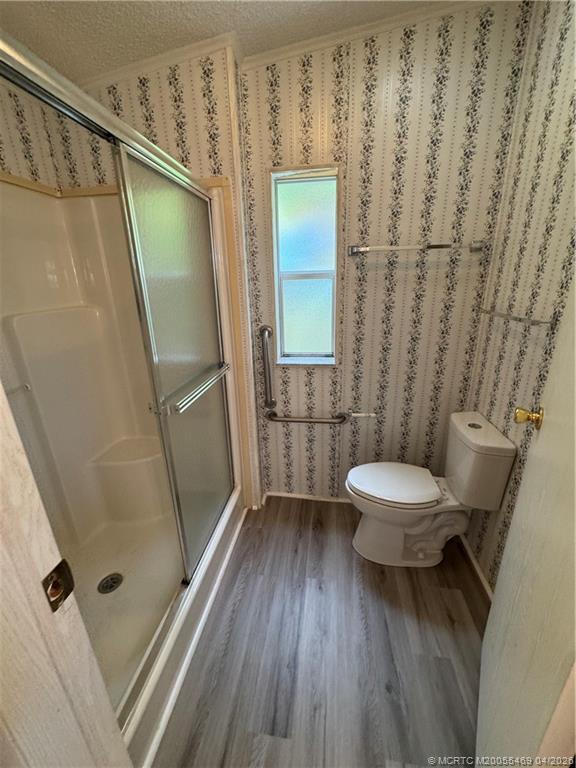 4236 Southeast Sweetwood Way Stuart, FL 34997 - Photo 24 of 50 a bathroom with a toilet and a shower