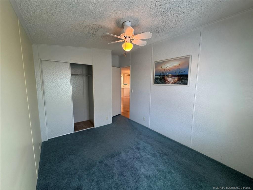 4236 Southeast Sweetwood Way Stuart, FL 34997 - Photo 26 of 50 a view of an empty room with window and a kitchen