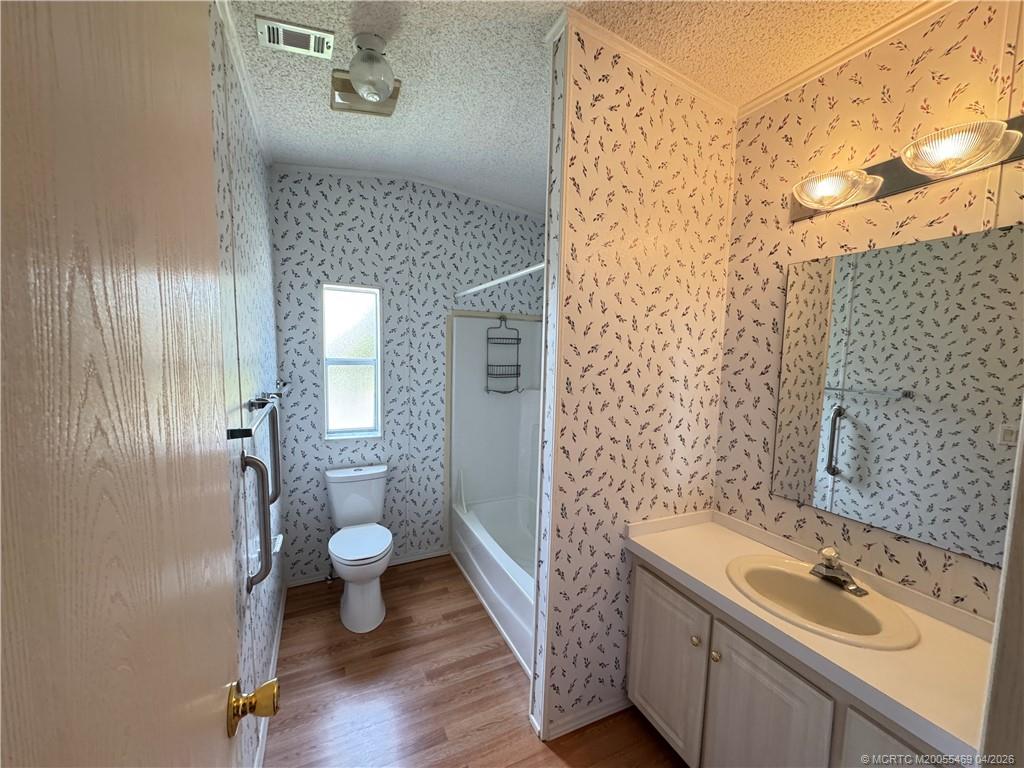 4236 Southeast Sweetwood Way Stuart, FL 34997 - Photo 27 of 50 a bathroom with a sink a toilet and shower