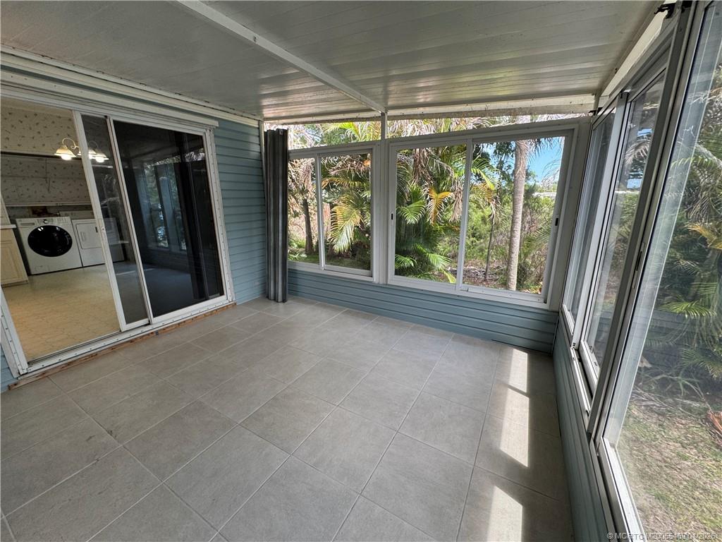 4236 Southeast Sweetwood Way Stuart, FL 34997 - Photo 29 of 50 a view of an empty room with a sliding door