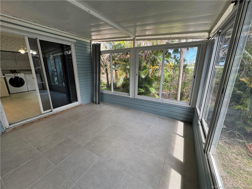 4236 Southeast Sweetwood Way Stuart, FL 34997 - Photo 30 of 50 a view of a glass door with a glass door and garden