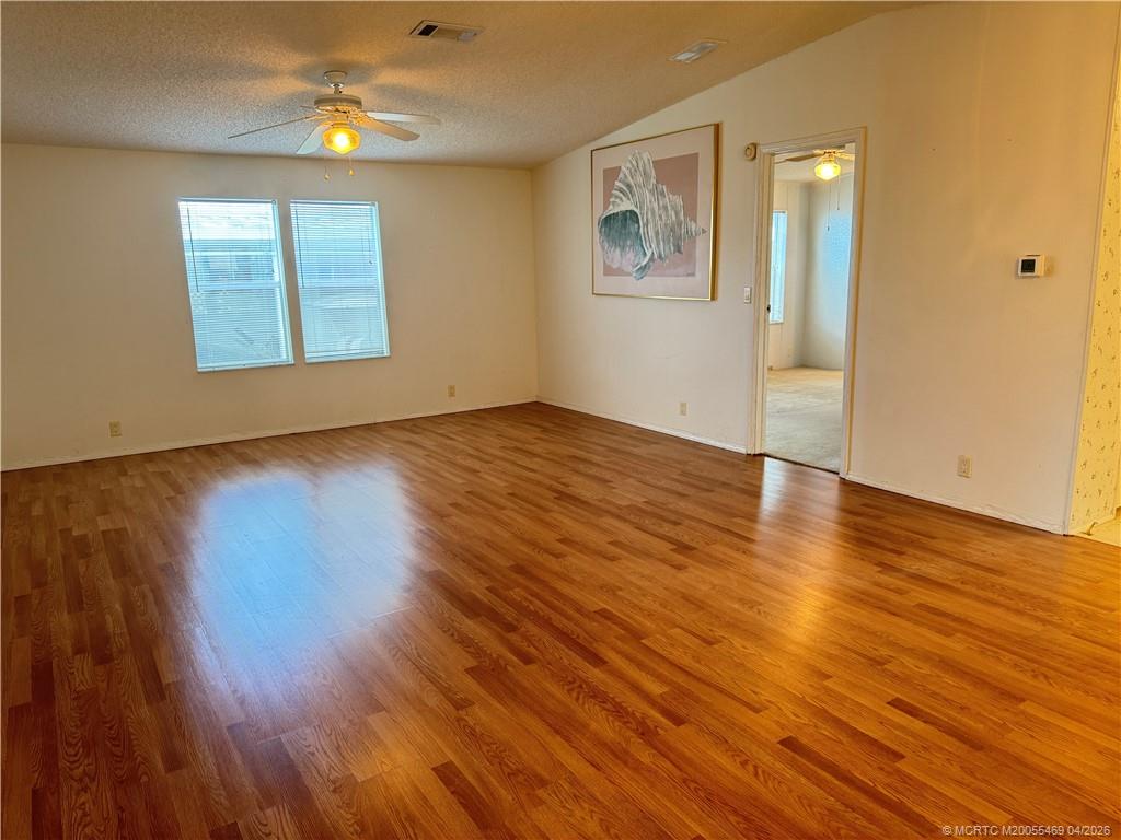4236 Southeast Sweetwood Way Stuart, FL 34997 - Photo 3 of 50 an empty room with wooden floor and windows