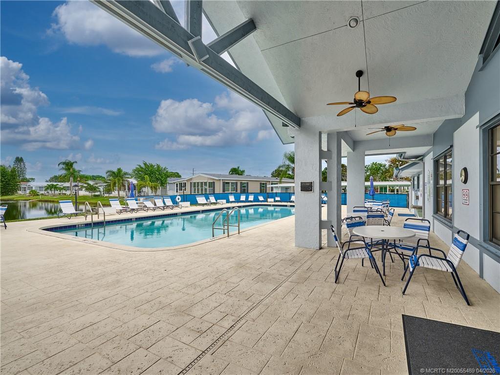 4236 Southeast Sweetwood Way Stuart, FL 34997 - Photo 41 of 50 a view of a swimming pool and outdoor seating