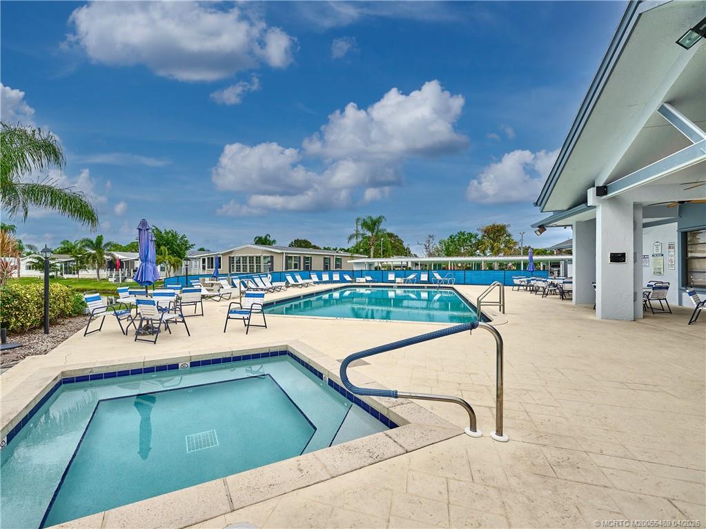 4236 Southeast Sweetwood Way Stuart, FL 34997 - Photo 42 of 50 a view of a swimming pool with outdoor seating