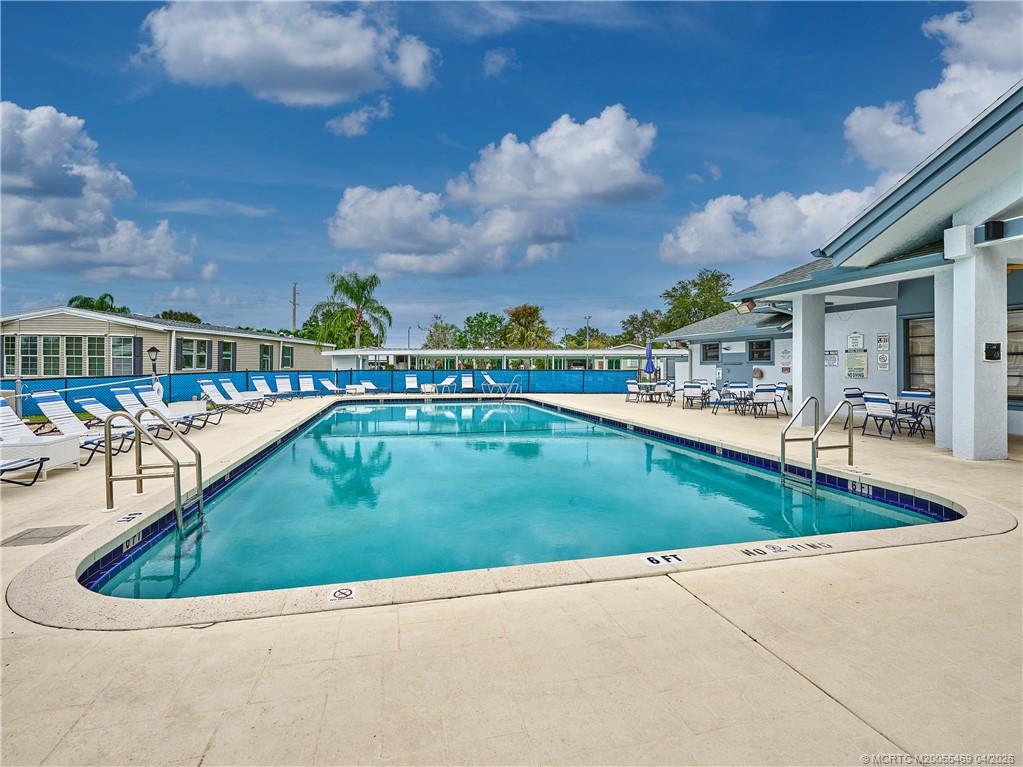 4236 Southeast Sweetwood Way Stuart, FL 34997 - Photo 43 of 50 a view of a swimming pool with a patio