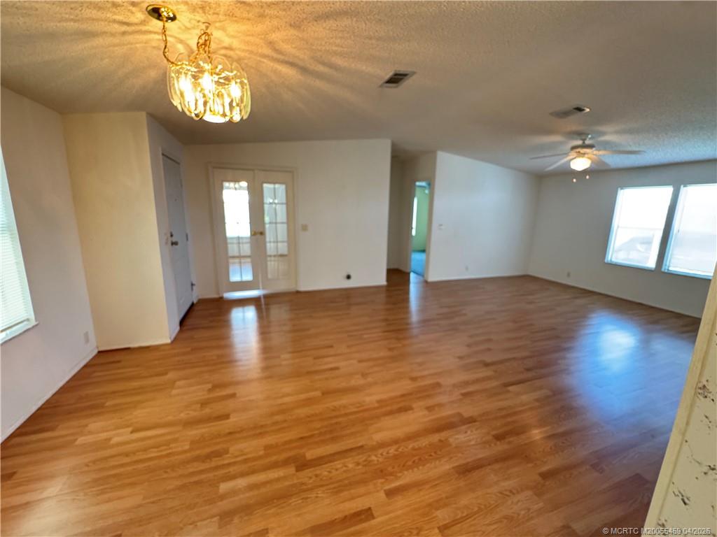 4236 Southeast Sweetwood Way Stuart, FL 34997 - Photo 5 of 50 a view of an empty room with window and wooden floor