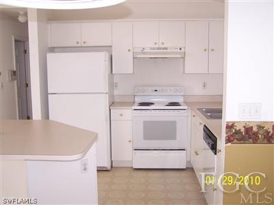 8405 Matanzas Road Fort Myers, FL 33967 - Photo 4 of 5 a kitchen with granite countertop white cabinets and white appliances