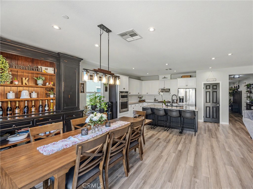 34512 Burnt Pine Road Murrieta, CA 92563 - Photo 3 of 21 a kitchen with stainless steel appliances granite countertop sink stove and wooden floor