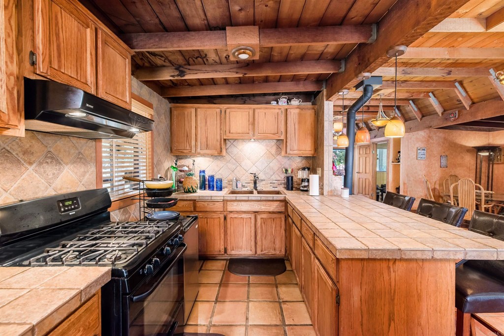 1168 Alpine Heights Road Alpine, CA 91901 - Photo 13 of 72 a kitchen with stainless steel appliances granite countertop a stove a sink dishwasher and cabinets with wooden floor