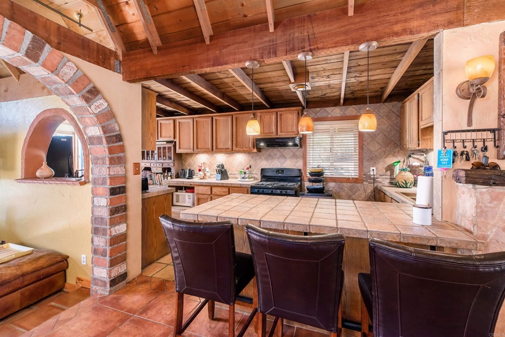 1168 Alpine Heights Road Alpine, CA 91901 - Photo 17 of 72 a kitchen with stainless steel appliances granite countertop a sink a counter space a sink cabinets and a window