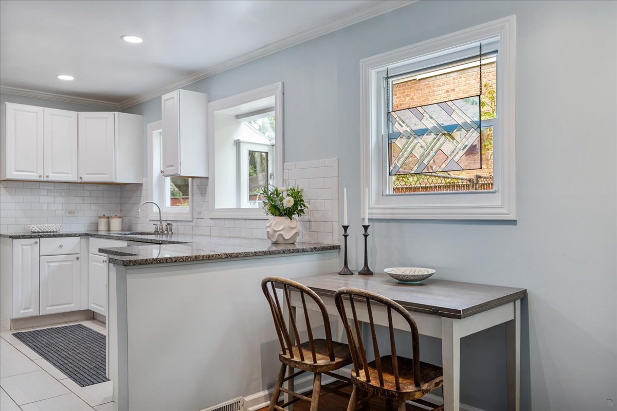 630 Long Road Glenview, IL 60025 - Photo 5 of 24 a kitchen with a table chairs sink and cabinets