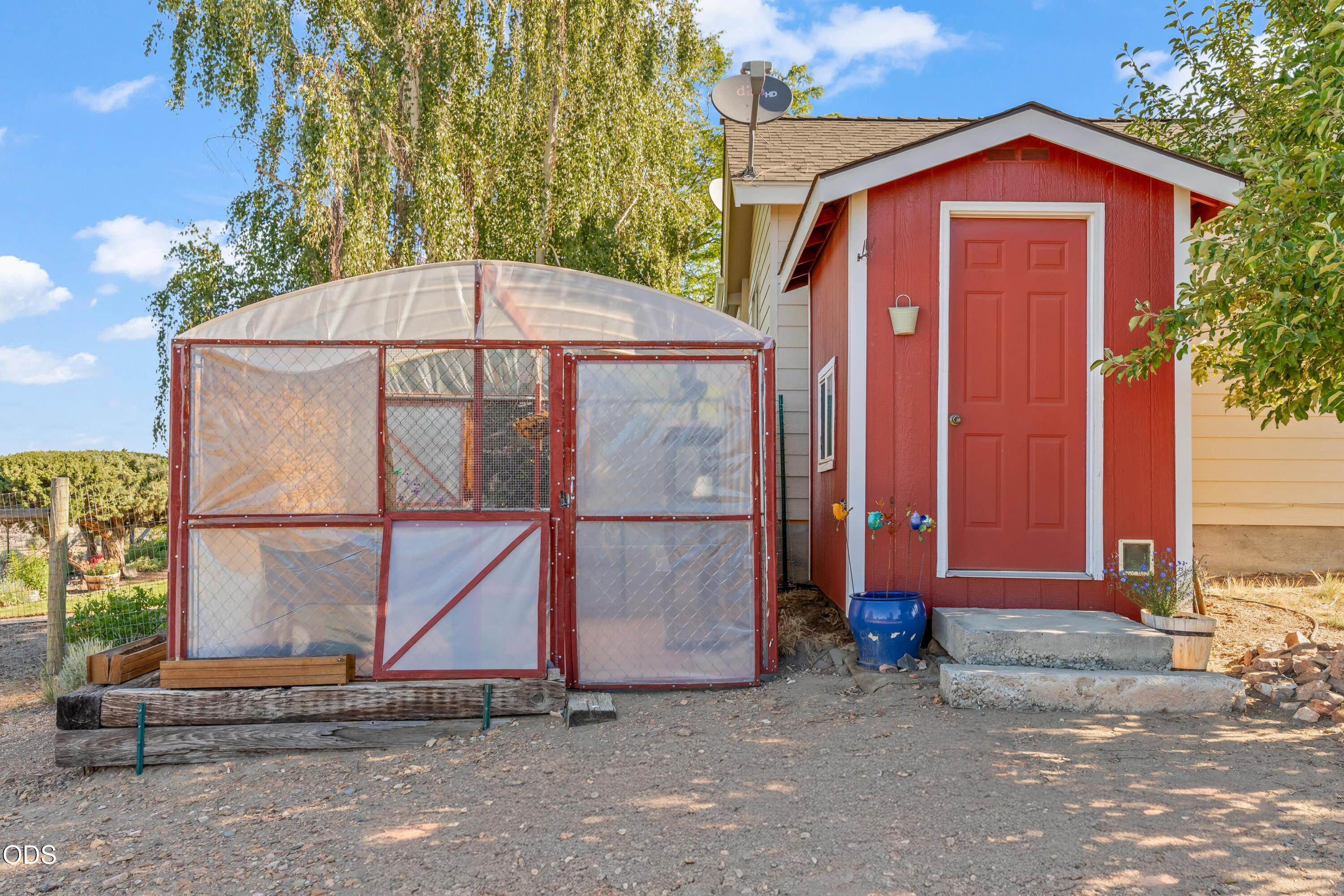 13753 South Sego Lily Road Powell Butte, OR 97753 - Photo 30 of 46 a view of backyard with a barn and a cactus plant
