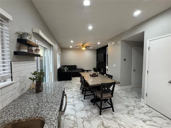 a kitchen with a dining table and chairs