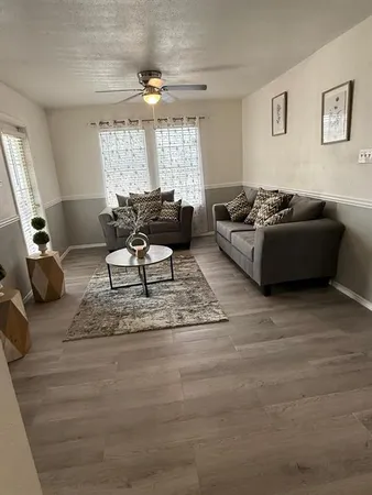 a living room with furniture and a large window