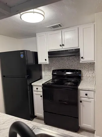a kitchen with a stove and a refrigerator
