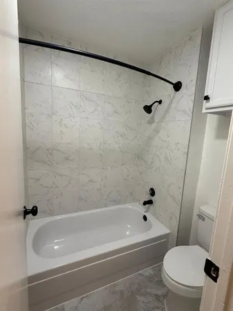 a bathroom with a bathtub and a toilet