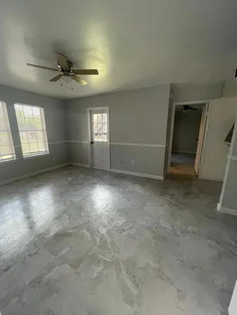 an empty room with a empty space and windows