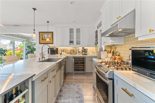 a kitchen with stainless steel appliances kitchen island granite countertop a stove a sink and a microwave
