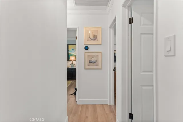 a view of a hallway with wooden floor and closet