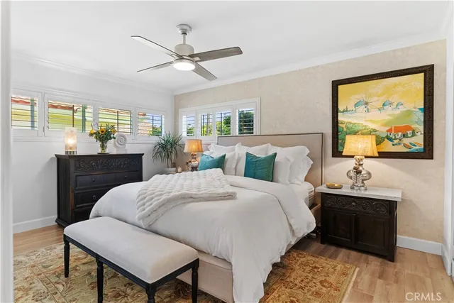 a bedroom with a bed and a dresser next to a window