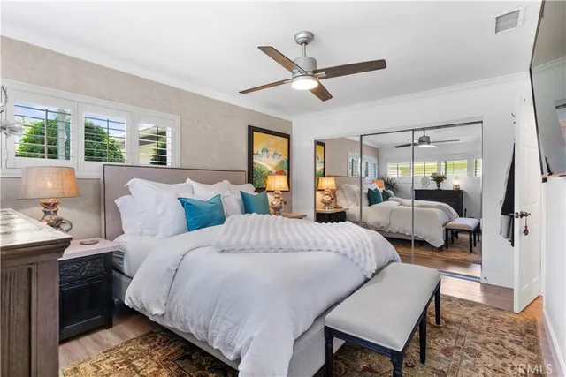 a spacious bedroom with two beds and a large mirror