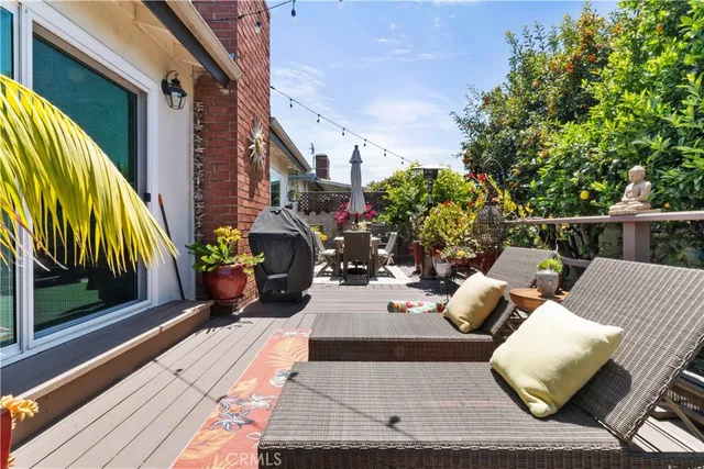 a view of a patio with couches table and chairs and potted plants