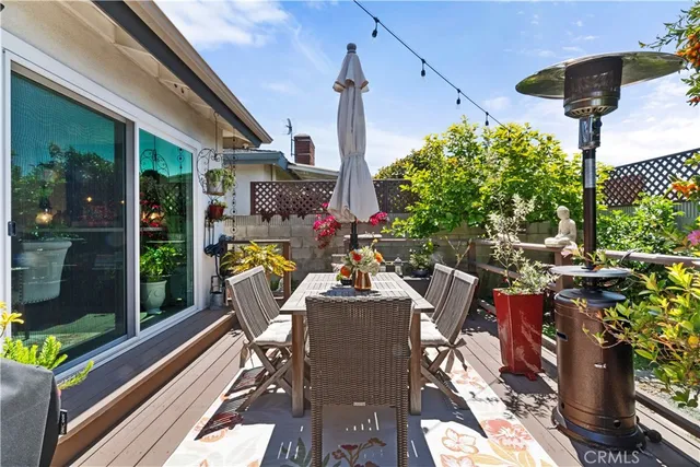 a view of a patio with table and chairs potted plants