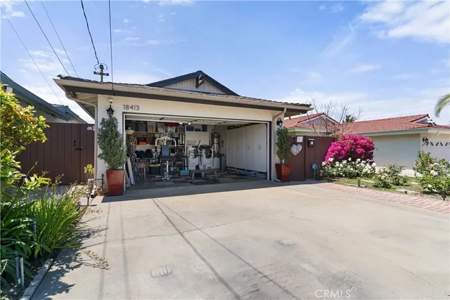 a view of a house with potted plants