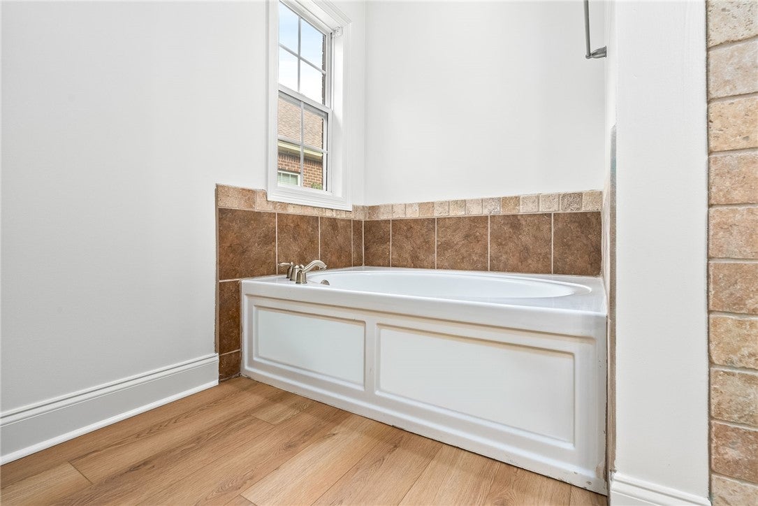 1756 Vfw Road Auburn, AL 36830 - Photo 13 of 26 A large soaking tub is a great spot to relax. A linen closet is located opposite of the tub.
