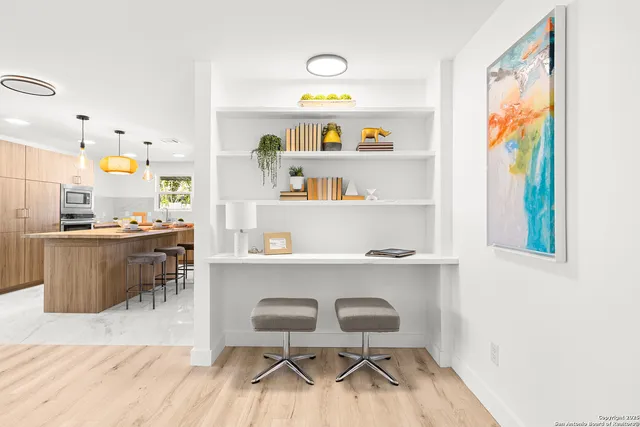 a room with a wooden floor and a dining table