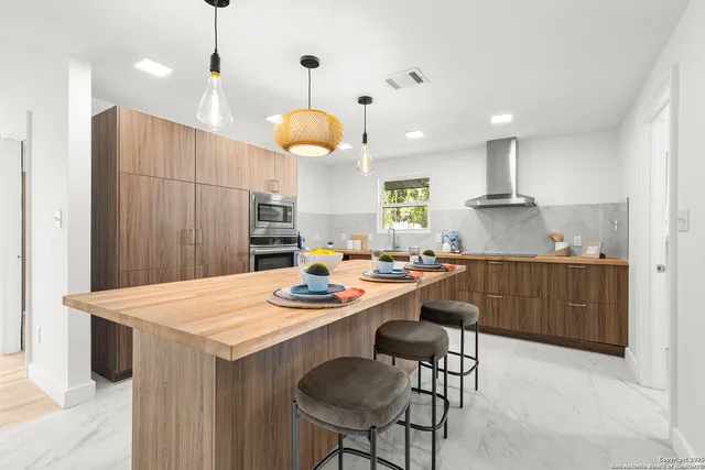 a large kitchen with a table and chairs