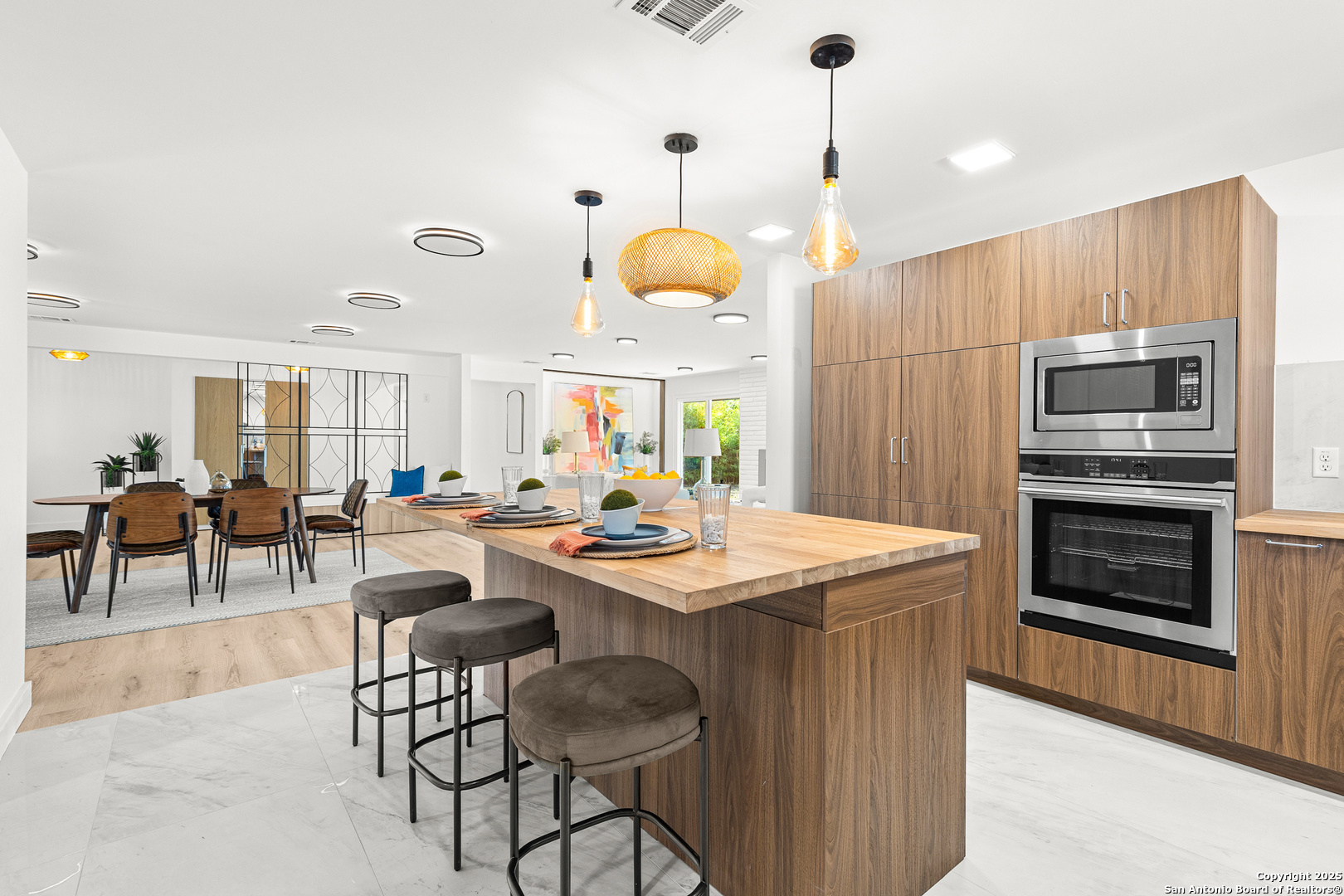 446 Spaceway Drive Windcrest, TX 78239 - Photo 14 of 28 a room with stainless steel appliances kitchen island granite countertop a stove a sink a dining table and chairs with wooden floor