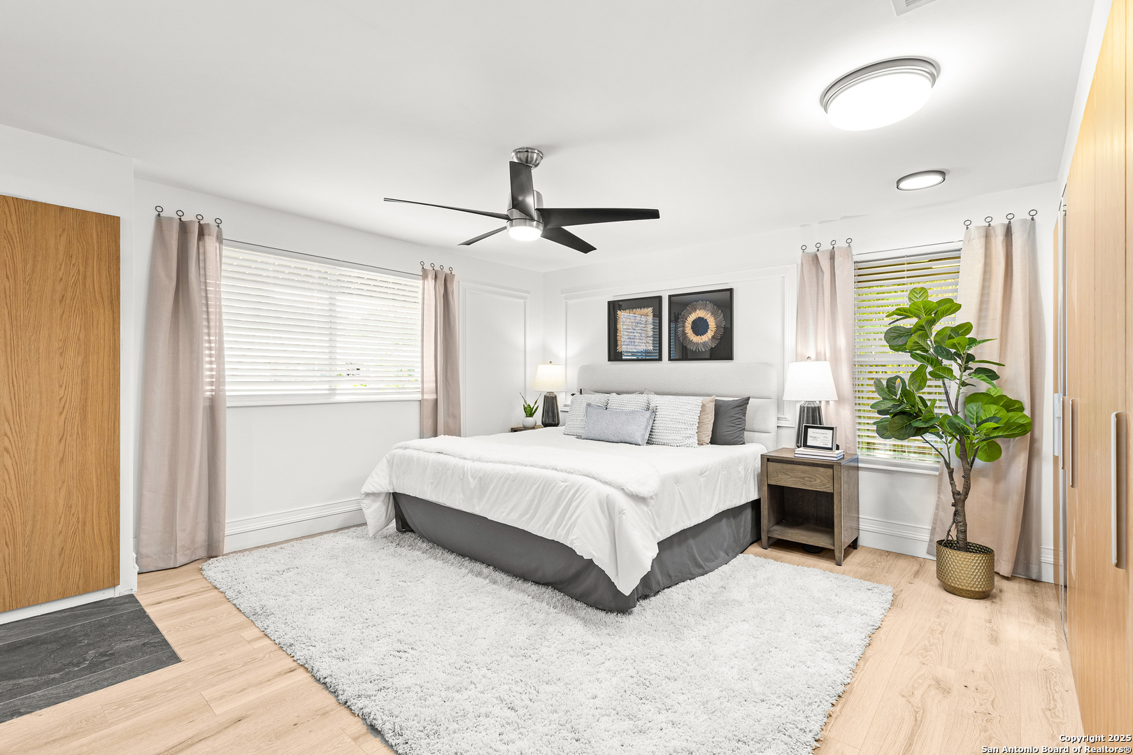 446 Spaceway Drive Windcrest, TX 78239 - Photo 18 of 28 a spacious bedroom with a large bed and a chandelier