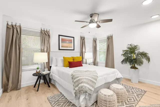 a bedroom with a large bed and a chandelier