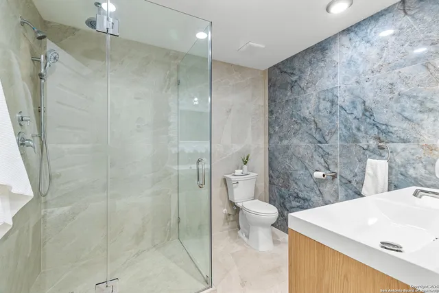 a bedroom with a bed and painting on the wall