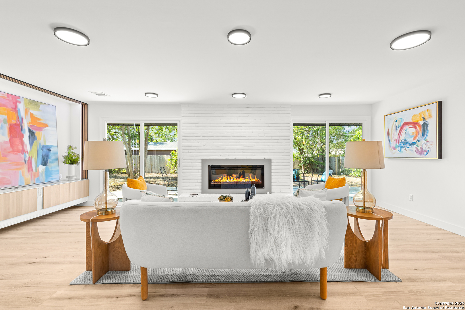 446 Spaceway Drive Windcrest, TX 78239 - Photo 6 of 28 a living room with furniture a large window and a fireplace