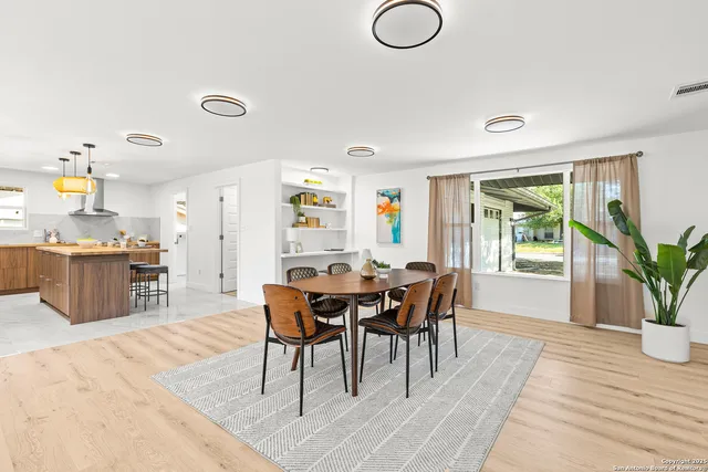 a dining room with furniture and window