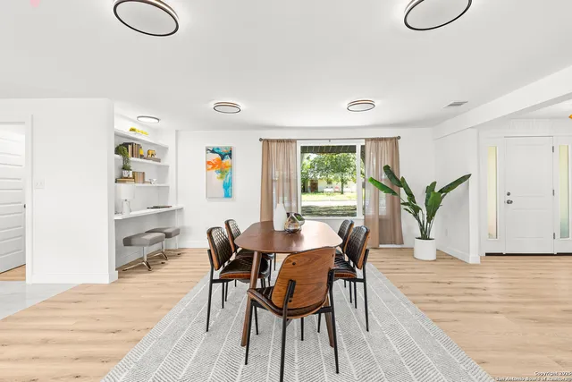 a view of a dining room with furniture and wooden floor
