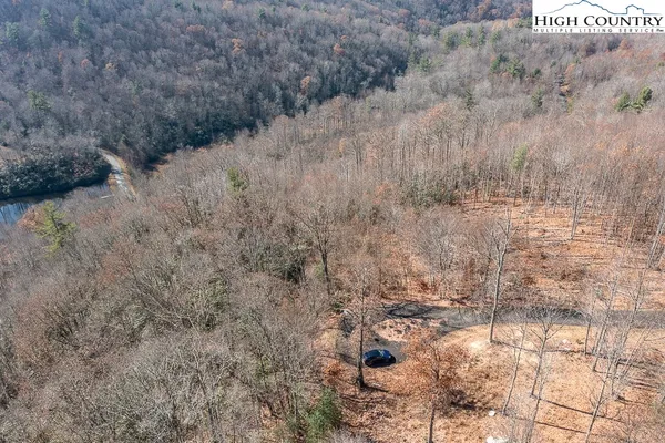 a view of a mountain range with trees in the background