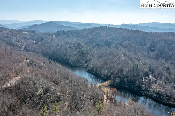 a view of a lake in middle of the forest