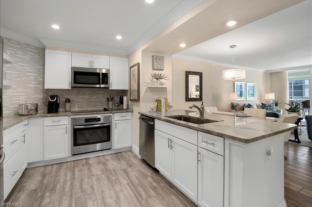 a kitchen with stainless steel appliances kitchen island granite countertop a sink and cabinets