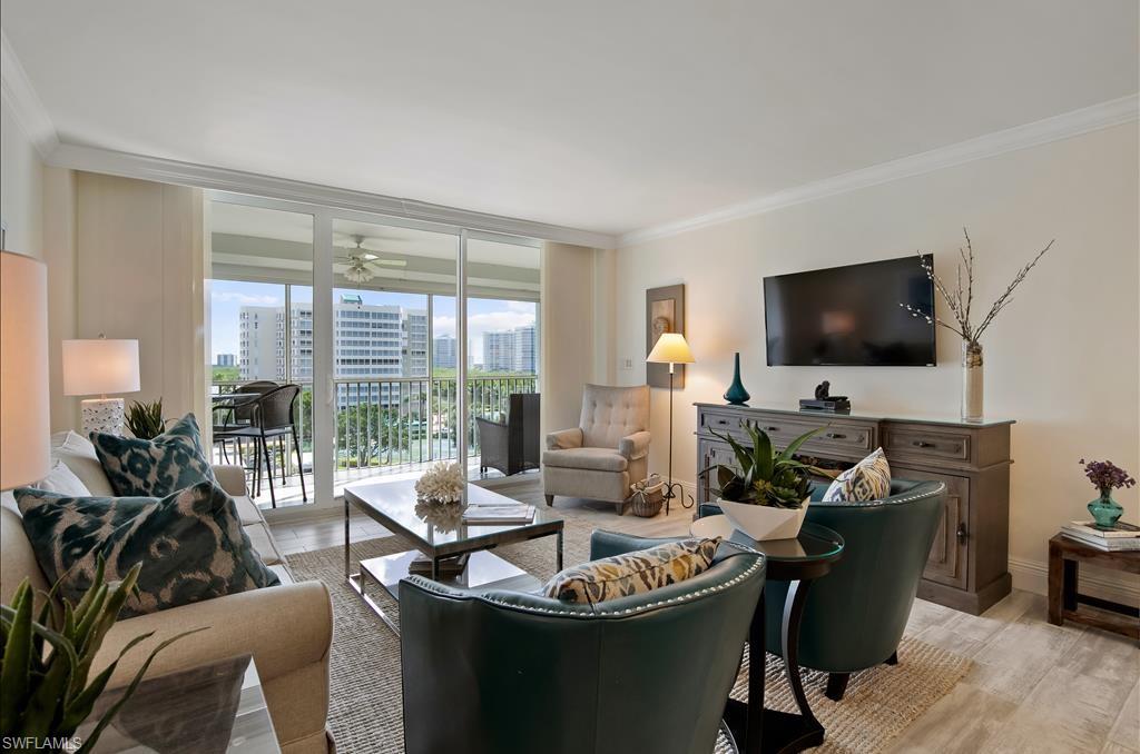 Undisclosed Address Naples, FL 34108 - Photo 4 of 14 a living room with furniture and a flat screen tv