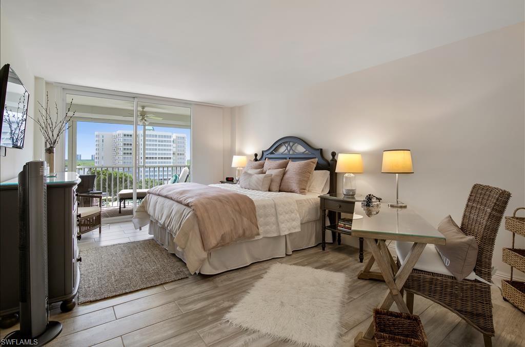 Undisclosed Address Naples, FL 34108 - Photo 8 of 14 a bedroom with a bed and a table