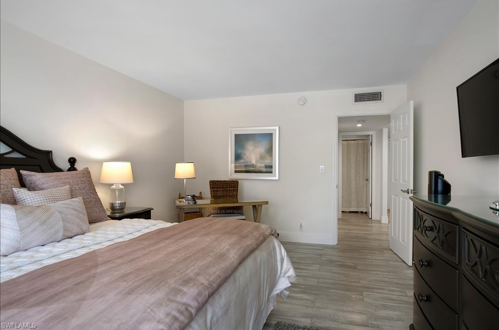 Undisclosed Address Naples, FL 34108 - Photo 9 of 14 a bedroom with a bed and a flat tv screen on dresser