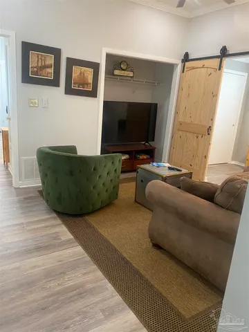 a living room with furniture and a flat screen tv