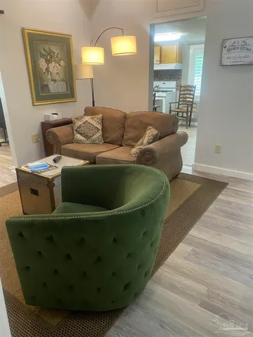 a living room with furniture and a lamp