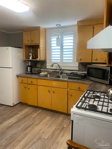 a kitchen with stainless steel appliances a sink dishwasher stove and refrigerator